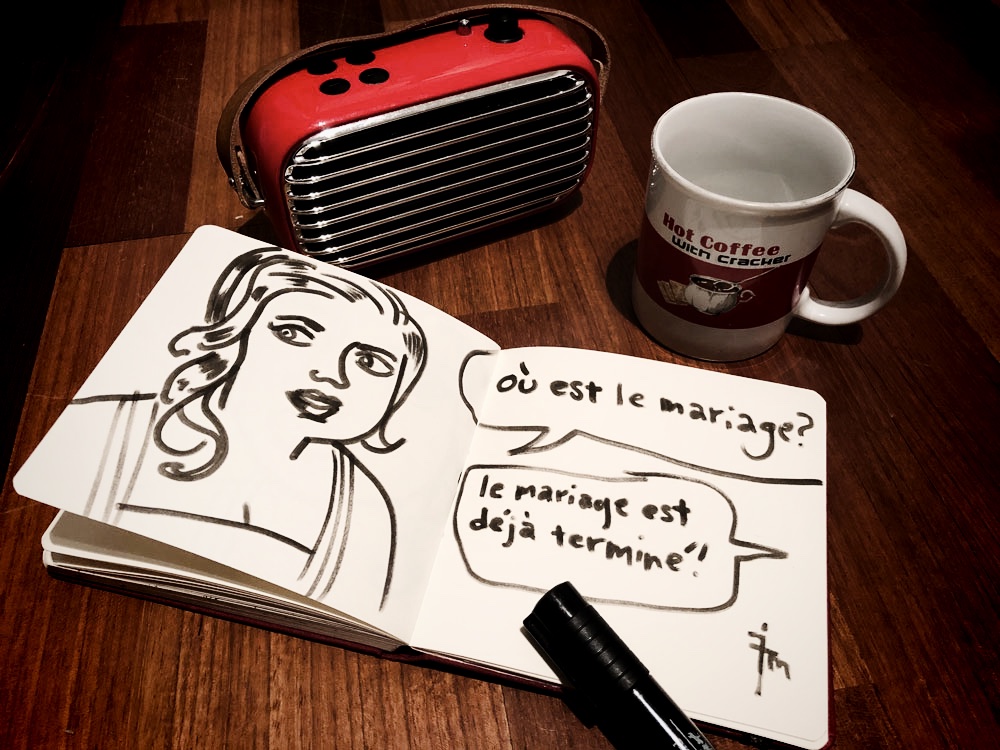 photo of sketchbook,radio,and cup on the floor.
