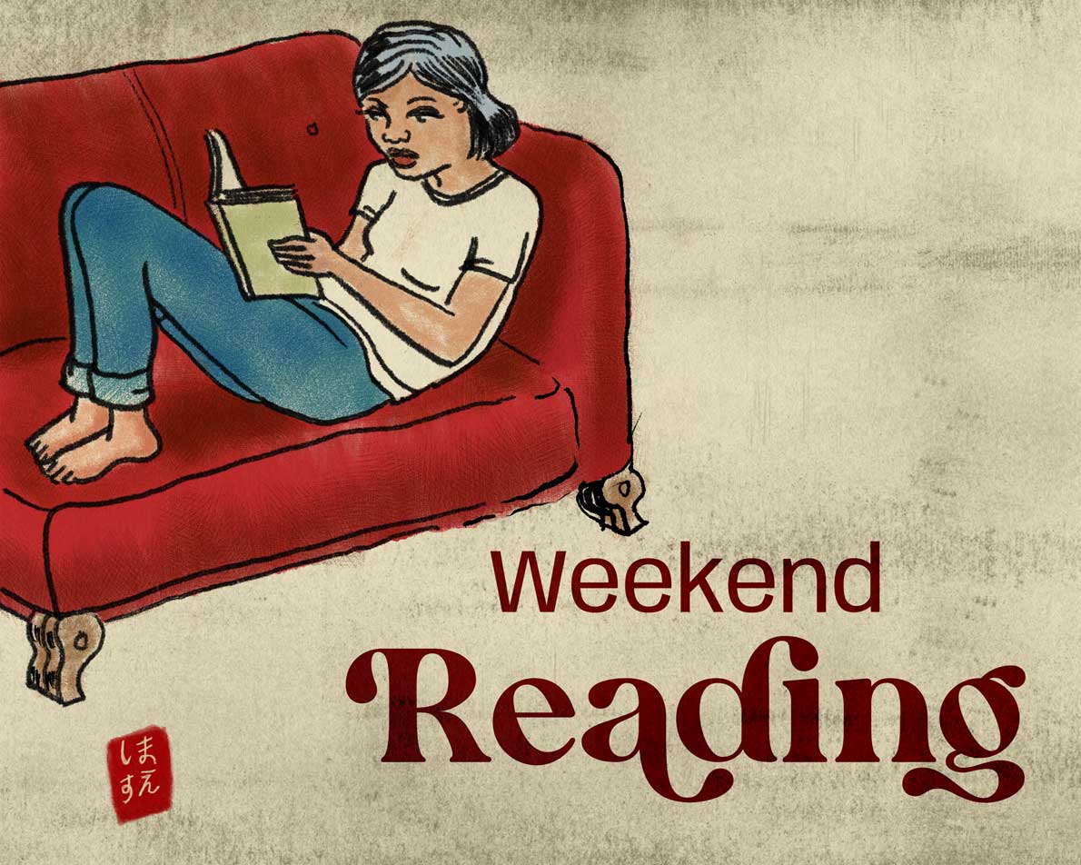 woman on red couch reading a book.