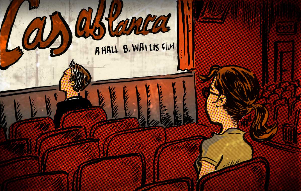 Image a woman sitting alone in a movie theatre.